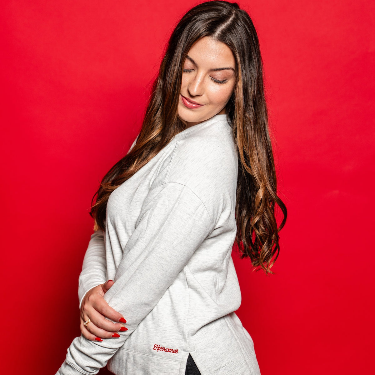 The crew being worn by a model in front of a red background