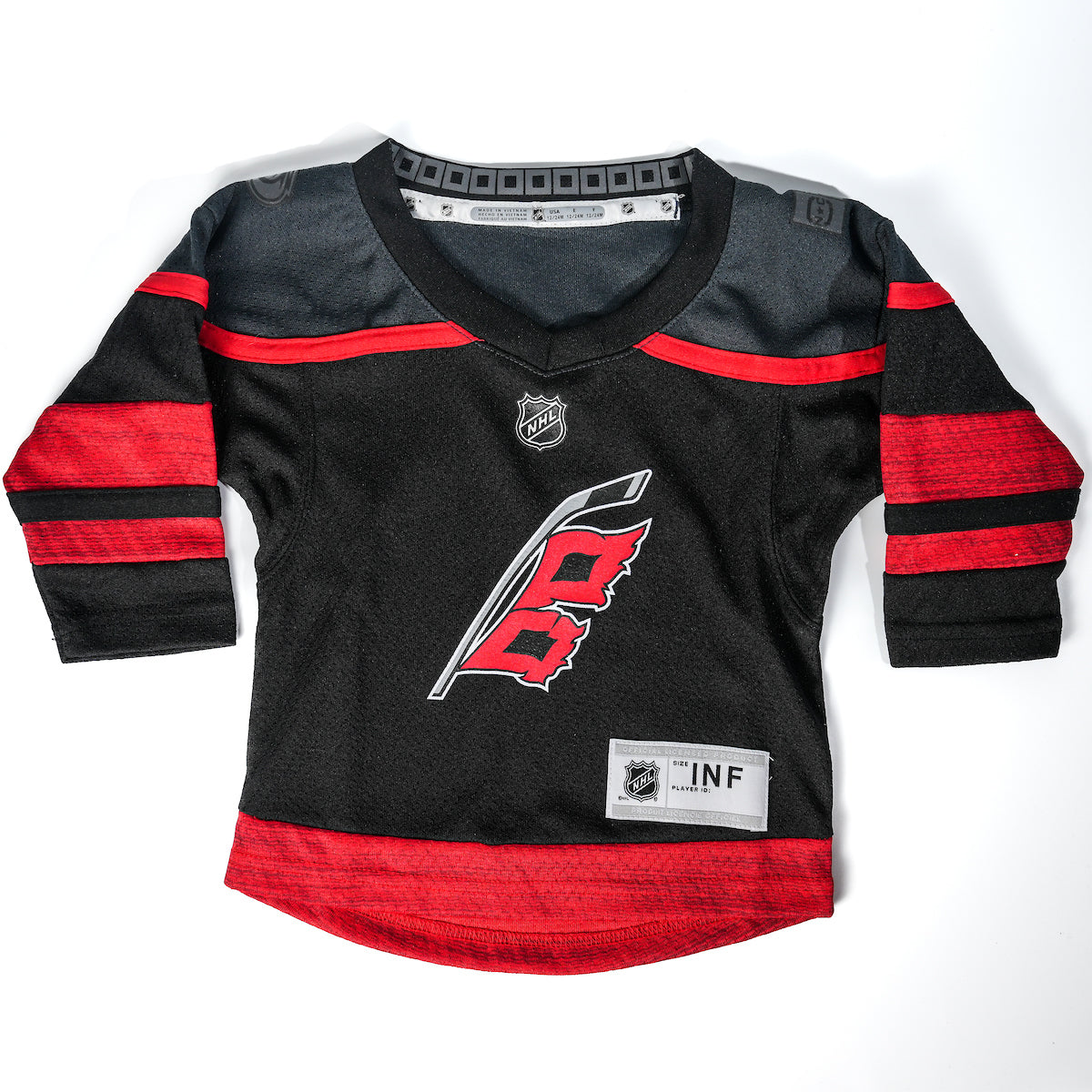 Front: black jersey with dark gray shoulders and red trim, Flags logo on front