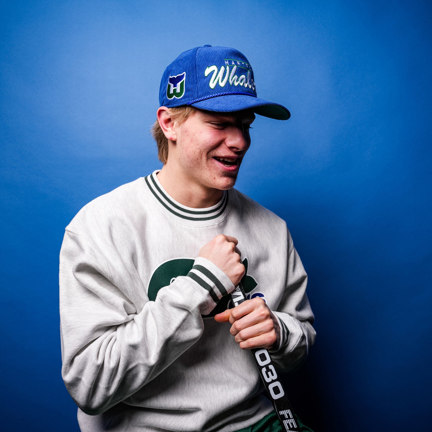 Hurricanes forward Jackson Blake posing with the hat on his head