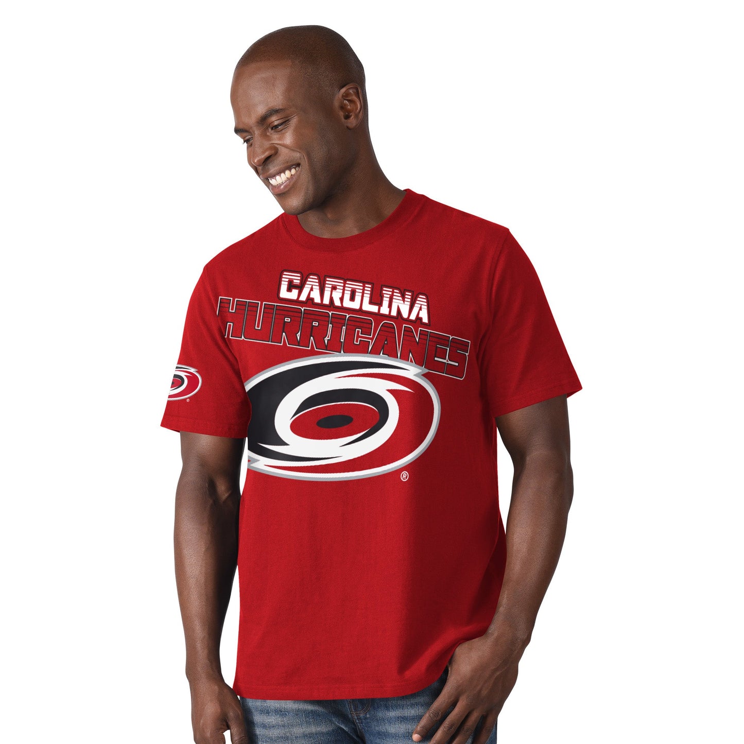 Red tee with large titled graphic across middle of tee, says Carolina Hurricanes with primary logo