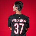 A model showcasing the back of the tee