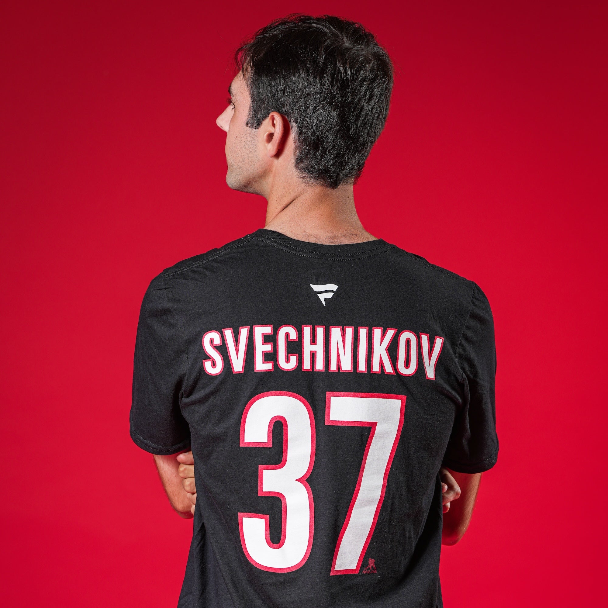 A model showcasing the back of the tee