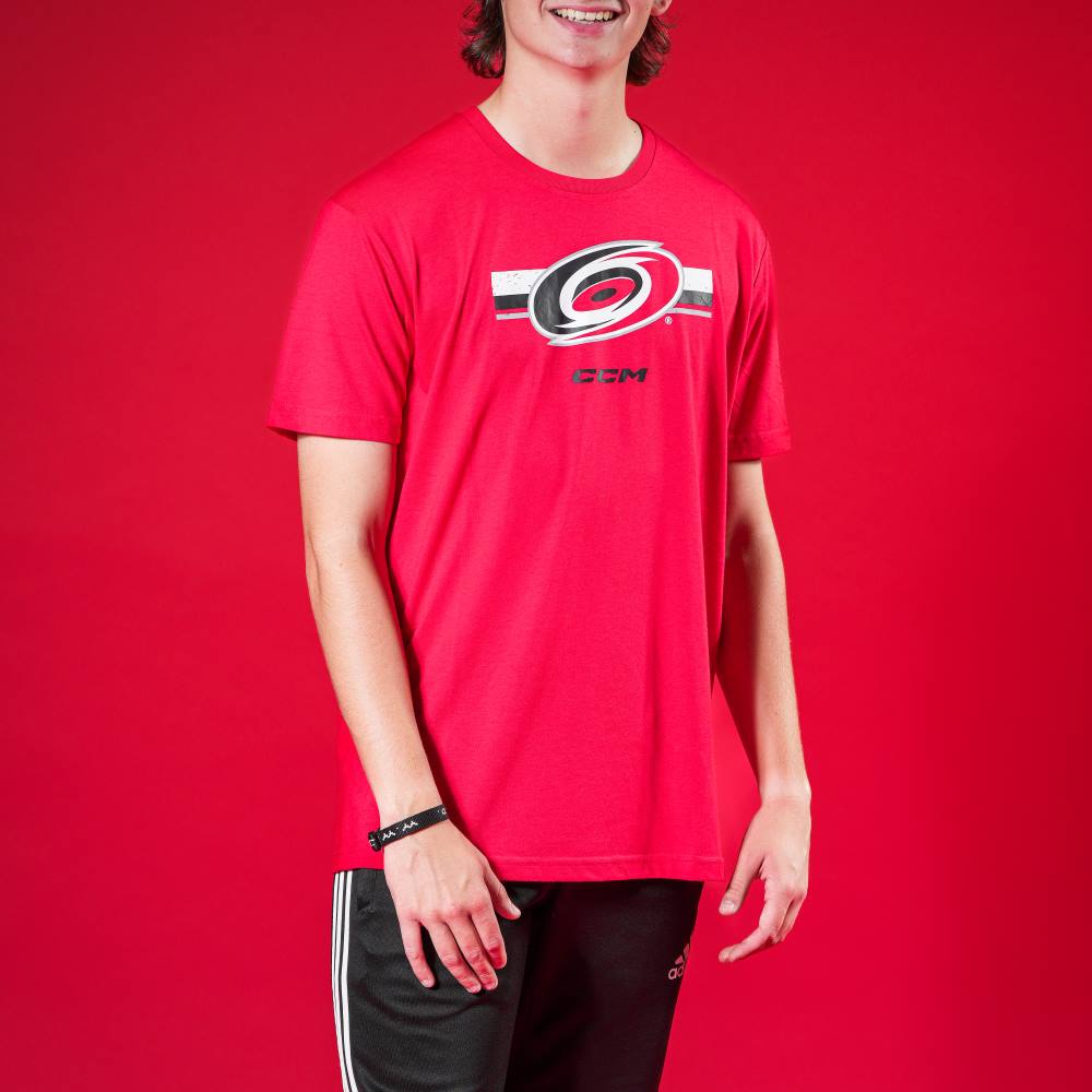 Red shirt with black and white striped graphic on front with Hurricanes primary logo, CCM logo below