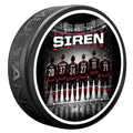 Puck with art of 6 Hurricanes standing at blueline, "SOUND THE SIREN" wordmark above skaters