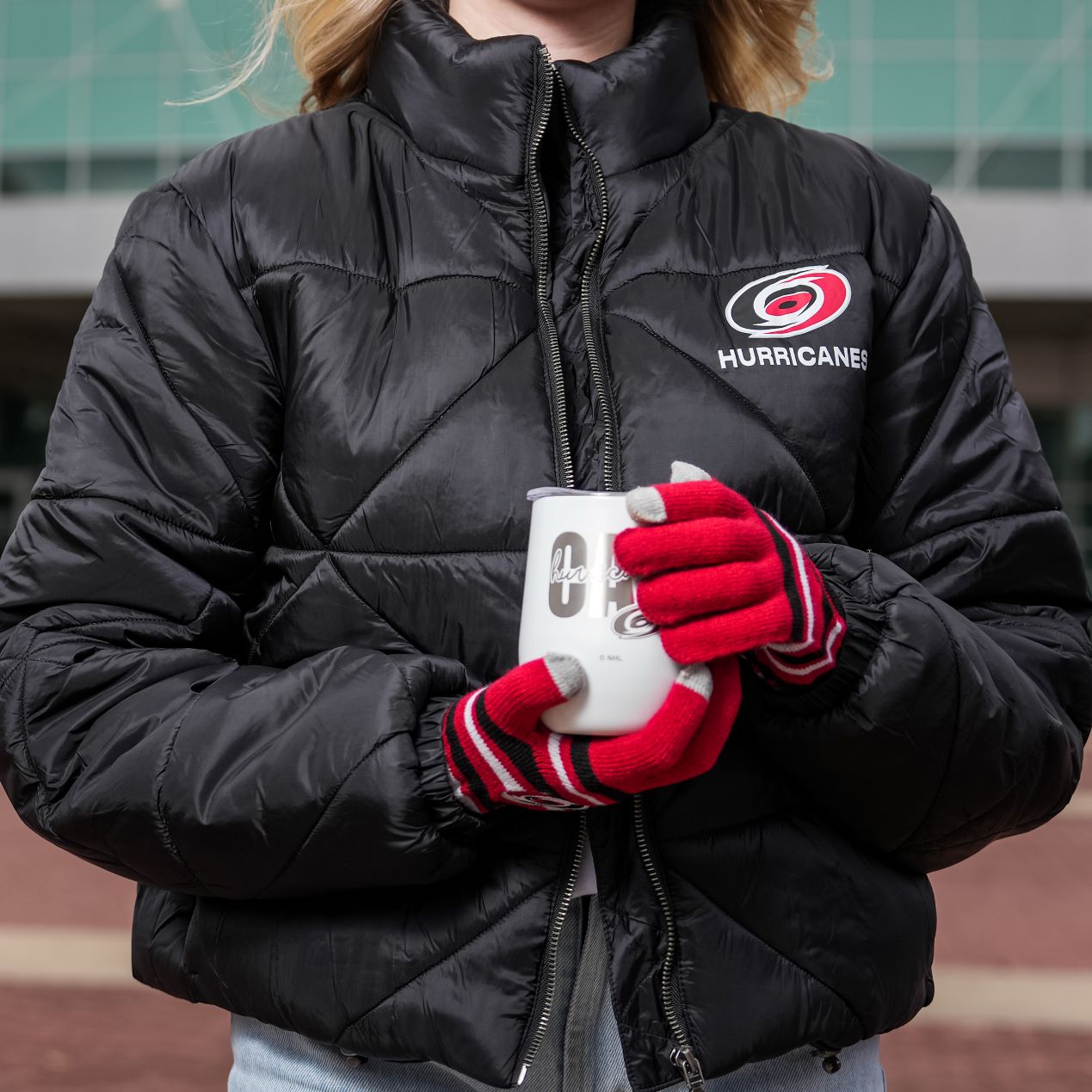 Black puffer jacket with primary logo on left chest, Hurricanes written below logo