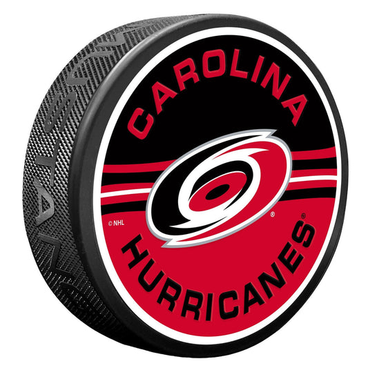 puck with half red half black face, says Carolina Hurricanes in red and black with primary logo