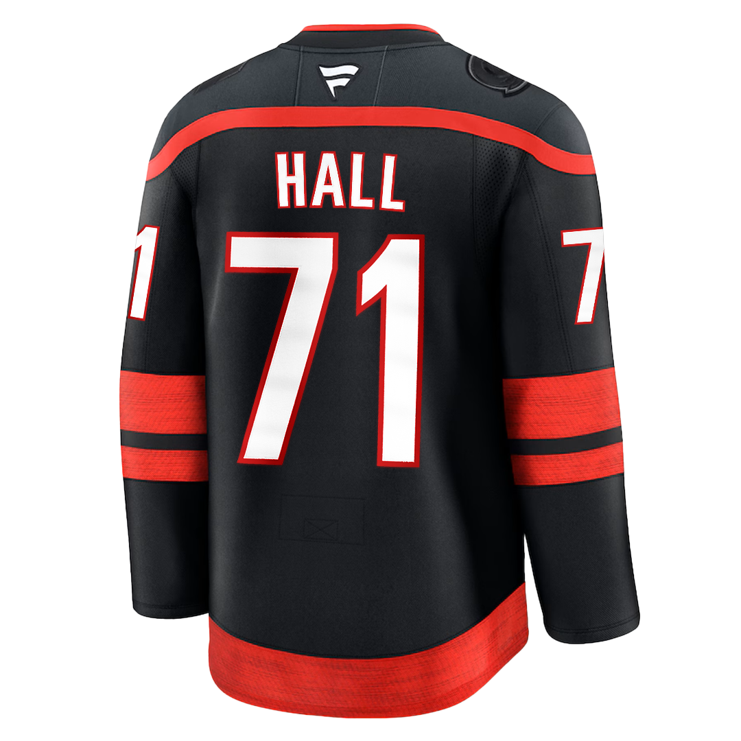 Back: Black Hurricanes jersey that says "Hall" and "71" in white and red lettering