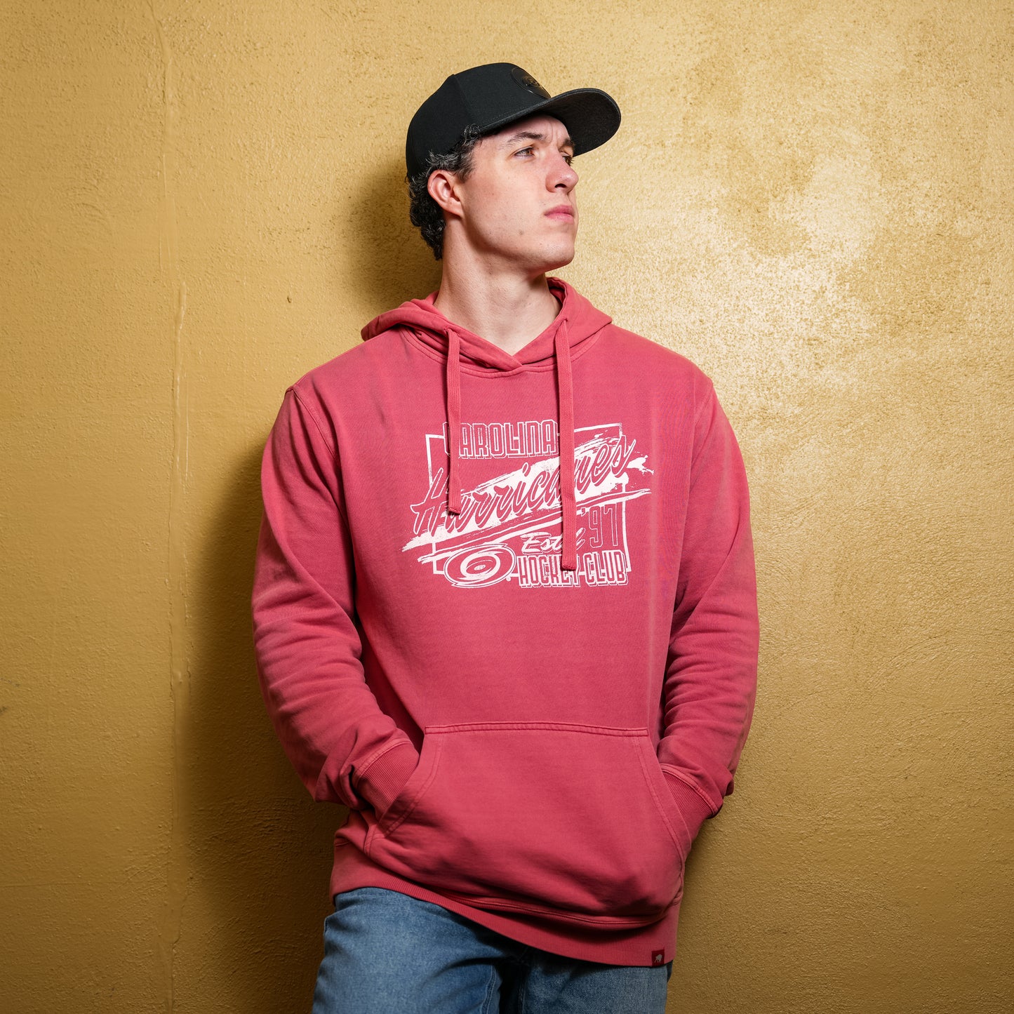 A model posing while wearing the hoodie