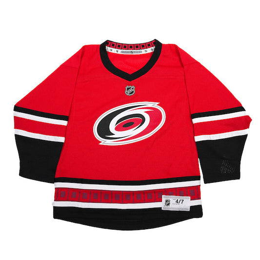 red jersey with black and white trim, Primary logo on front