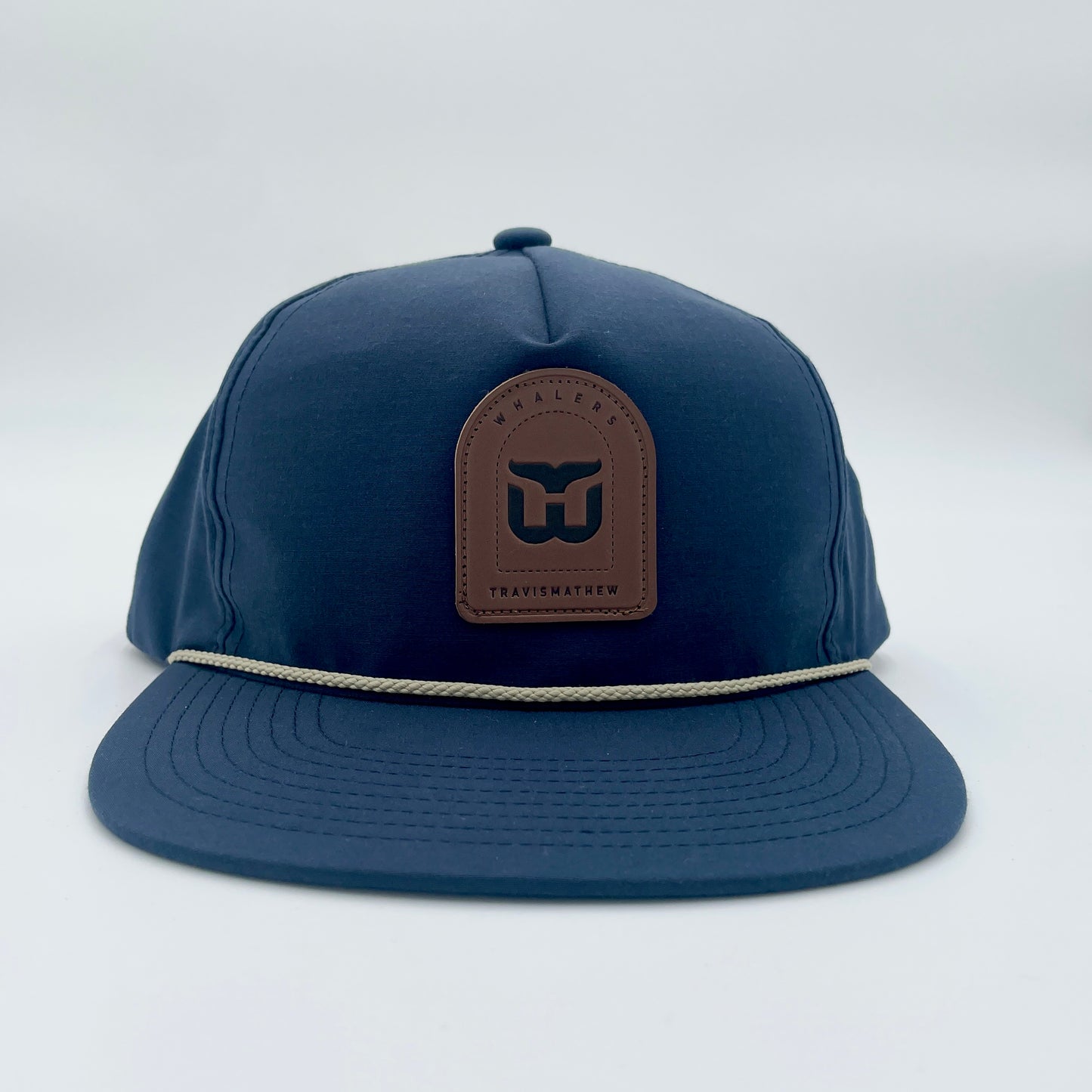 Front: Navy blue hat with tan rope, brown tombstone-shaped patch with Whalers logo