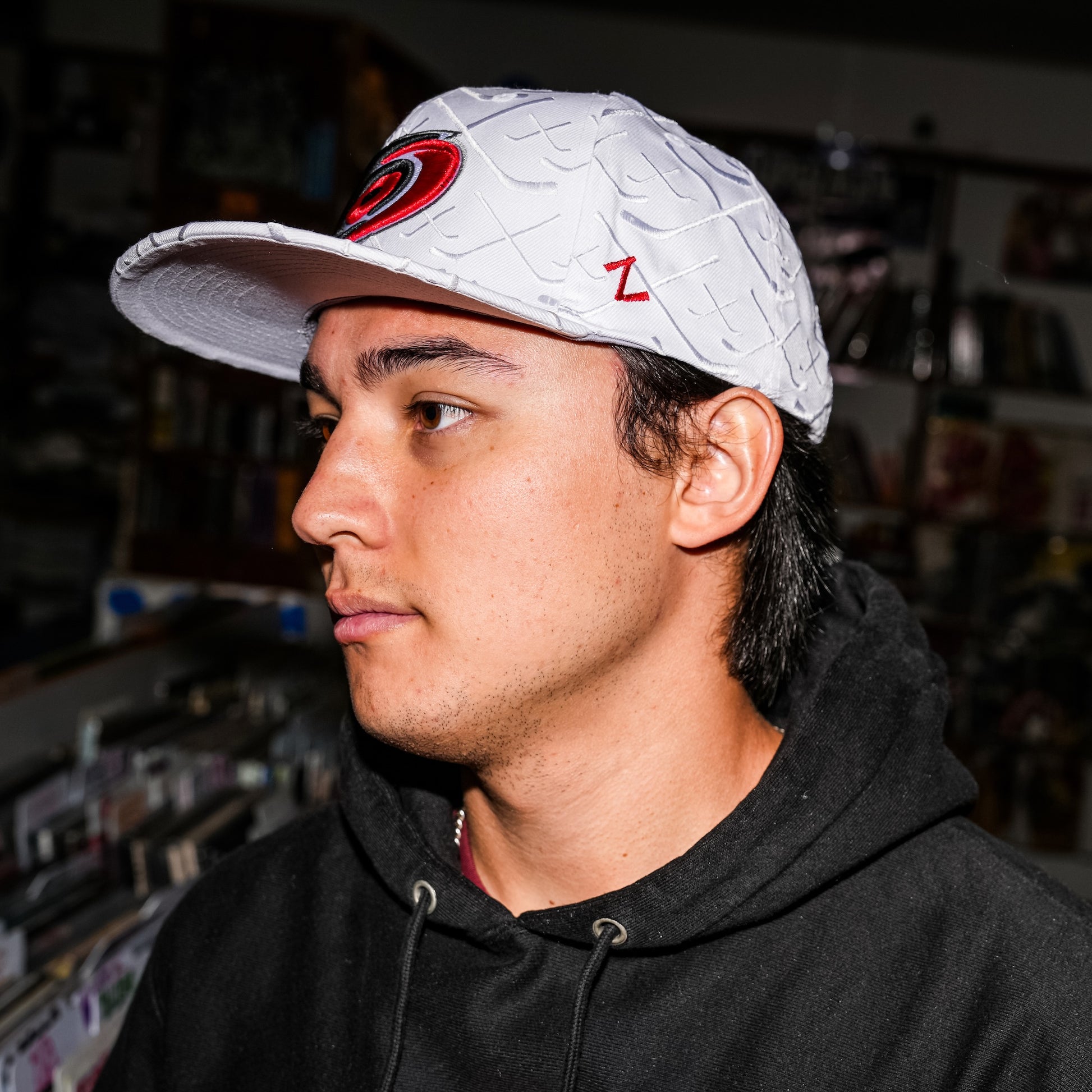 A model posing while wearing the hat in a record store