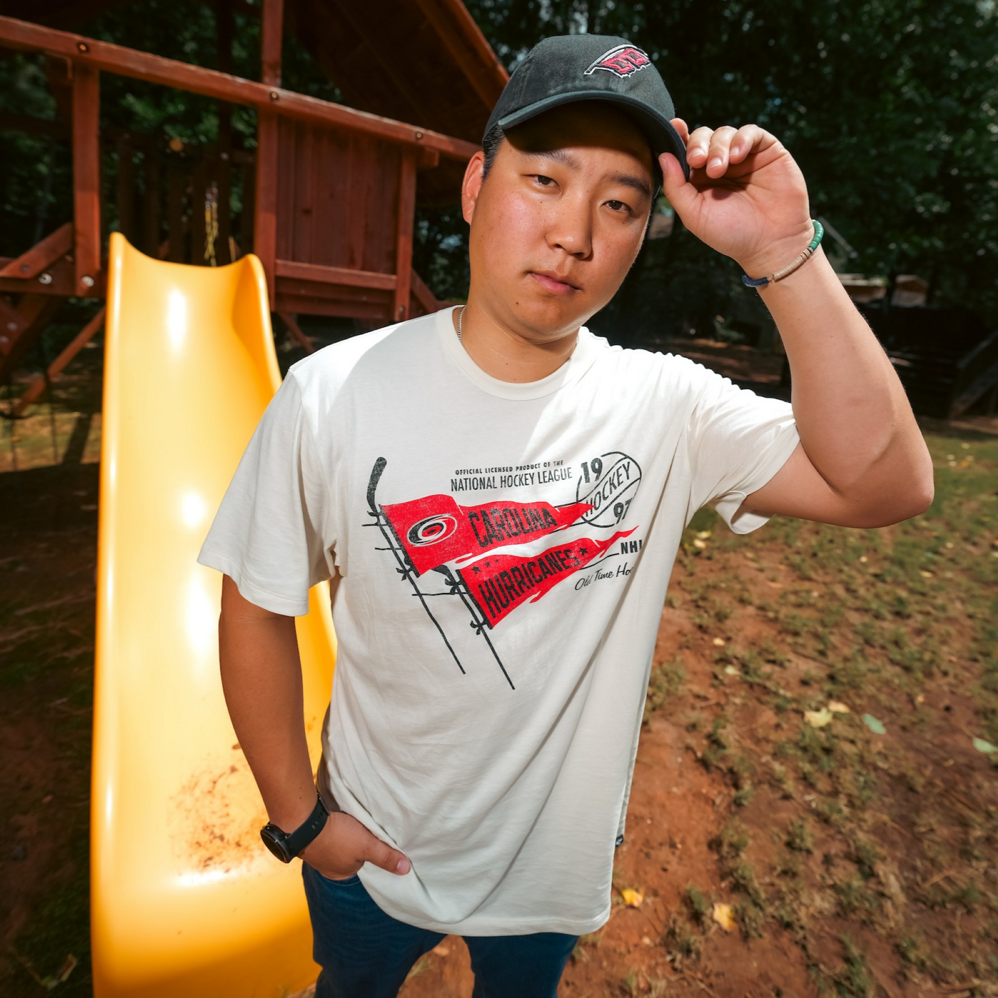 A model wearing the t-shirt in front of a slide