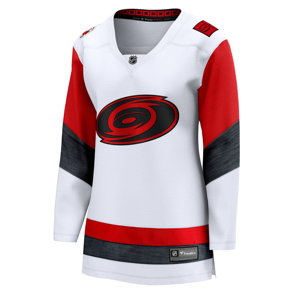 Front: White jersey, red/heather black striping, Tonal Primary logo crest, v-neck, slimmer cut