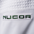 White patch with NUCOR logo in green lettering