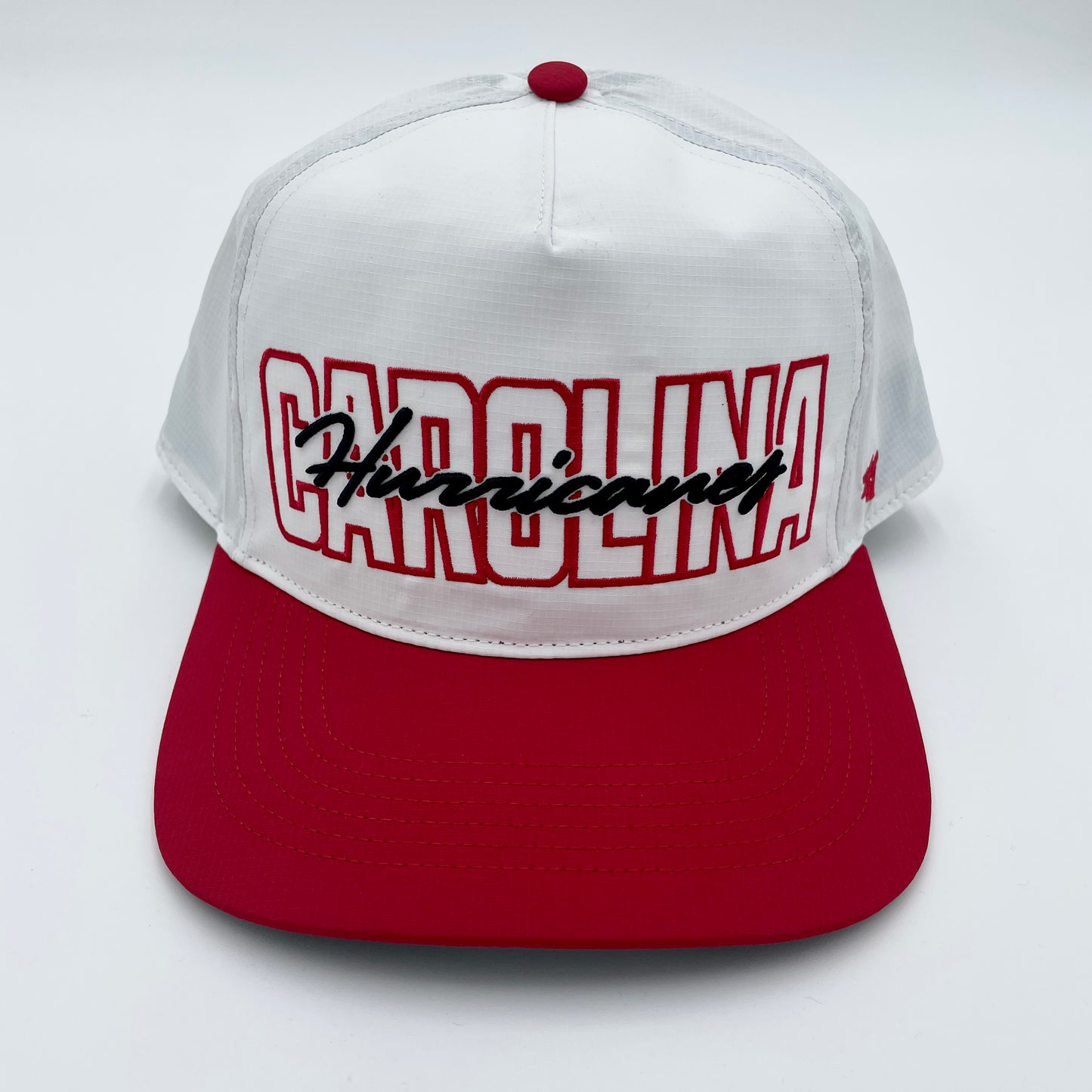 Front: White hat with red brim, Red and black graphic that says Carolina Hurricanes