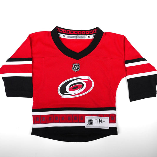 red jersey with black and white trim, Primary logo on front