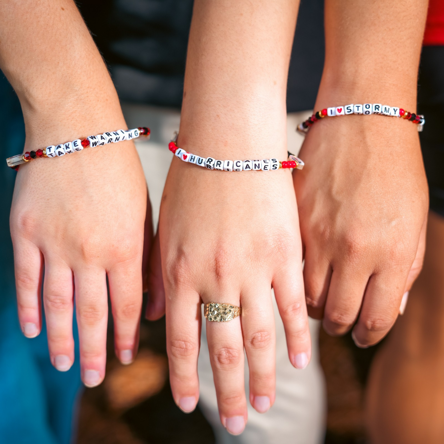 The 3 bracelets being worn by 3 models
