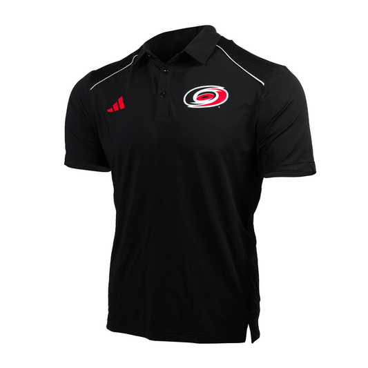 Black polo with white piping at shoulders, primary logo on left chest, red Adidas logo on right