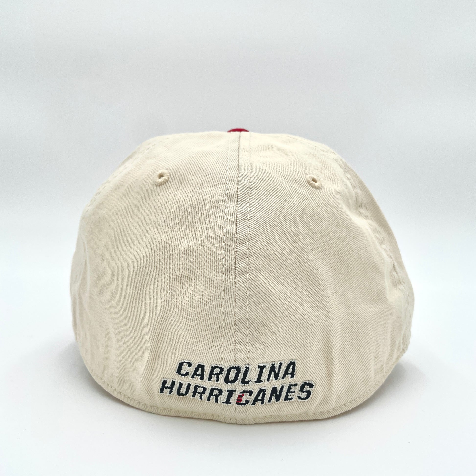 Back: Cream fitted hat with red crown, Carolina Hurricanes wordmark in black