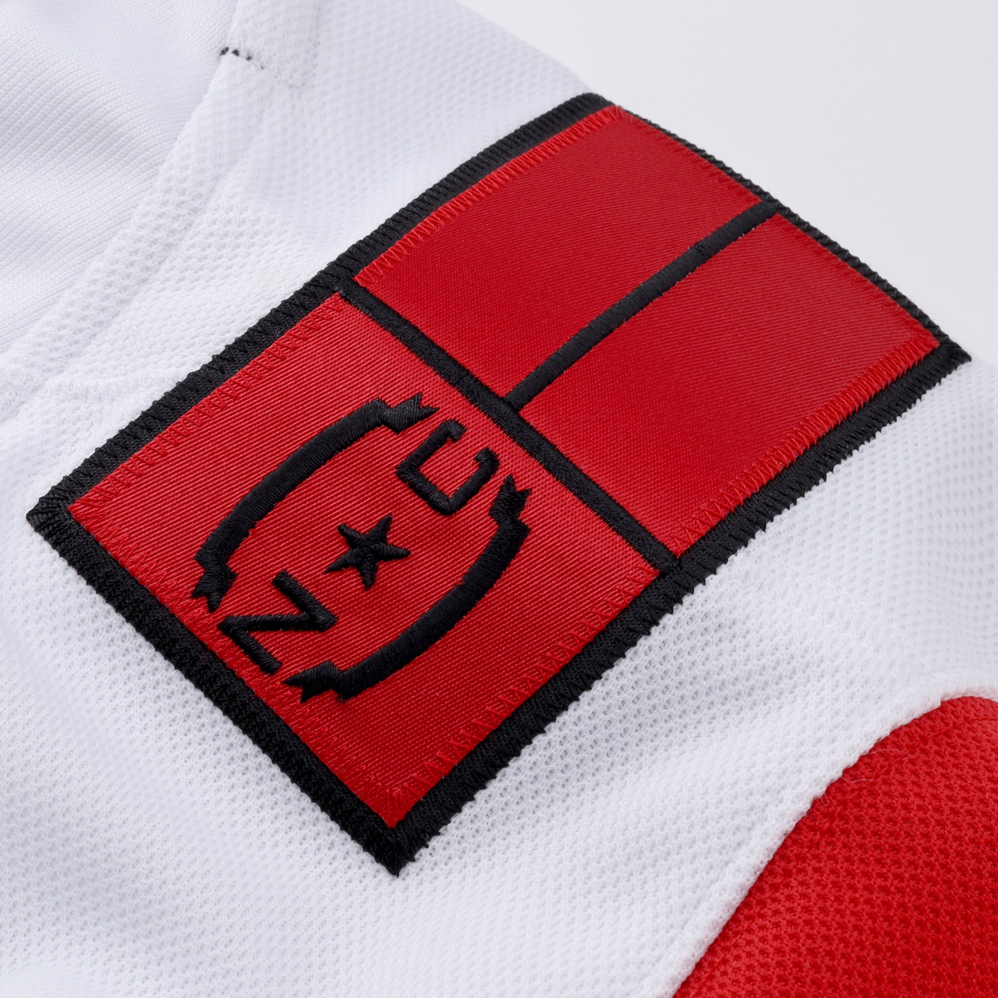 Close up of red NC State Flag patch on left shoulder