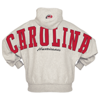 Back: "CAROLINA" in red across back/sleeves, "Hurricanes" in cursive below, Primary logo on hood
