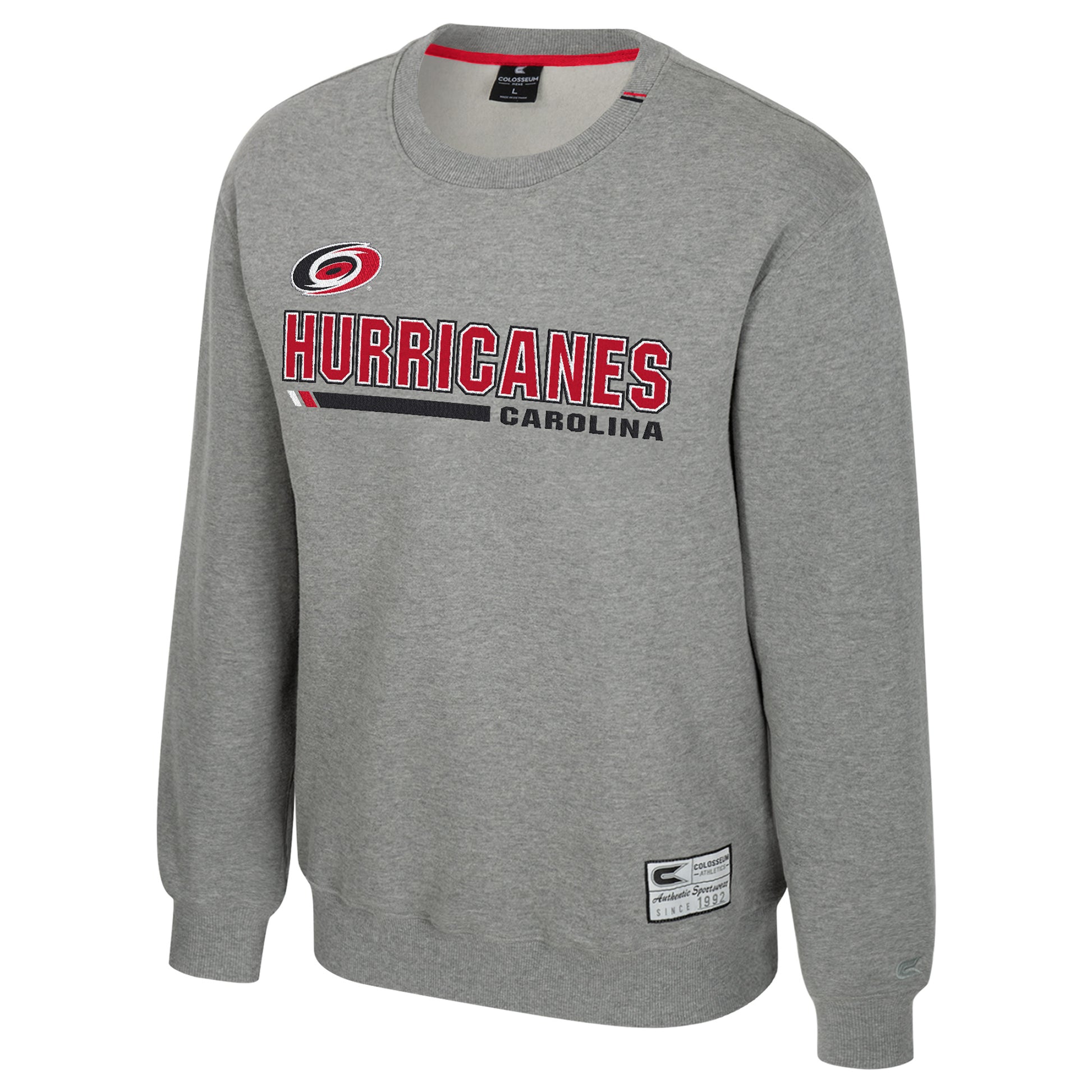Gray crewneck, "CAROLINA" in black, "HURRICANES" in red with primary logo, Colosseum tag at waist