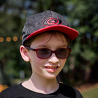 The hat being worn by a model in front of an outdoor background