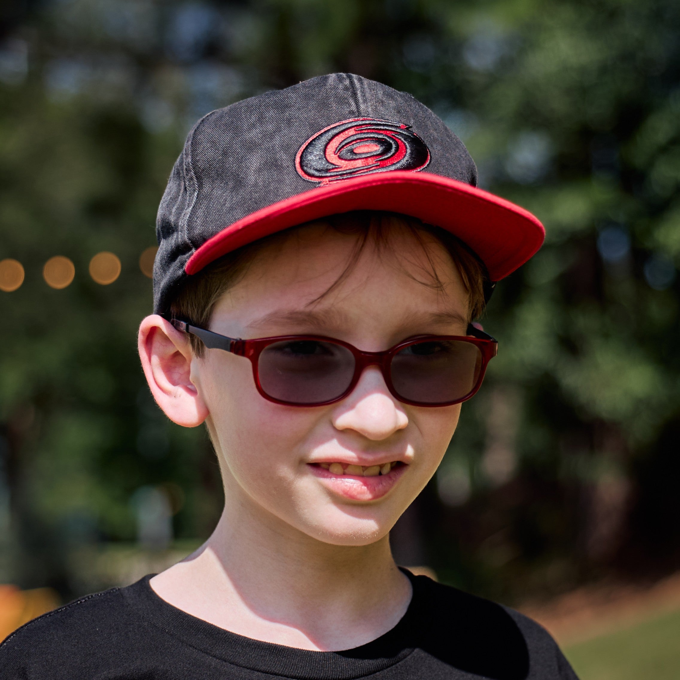 The hat being worn by a model in front of an outdoor background