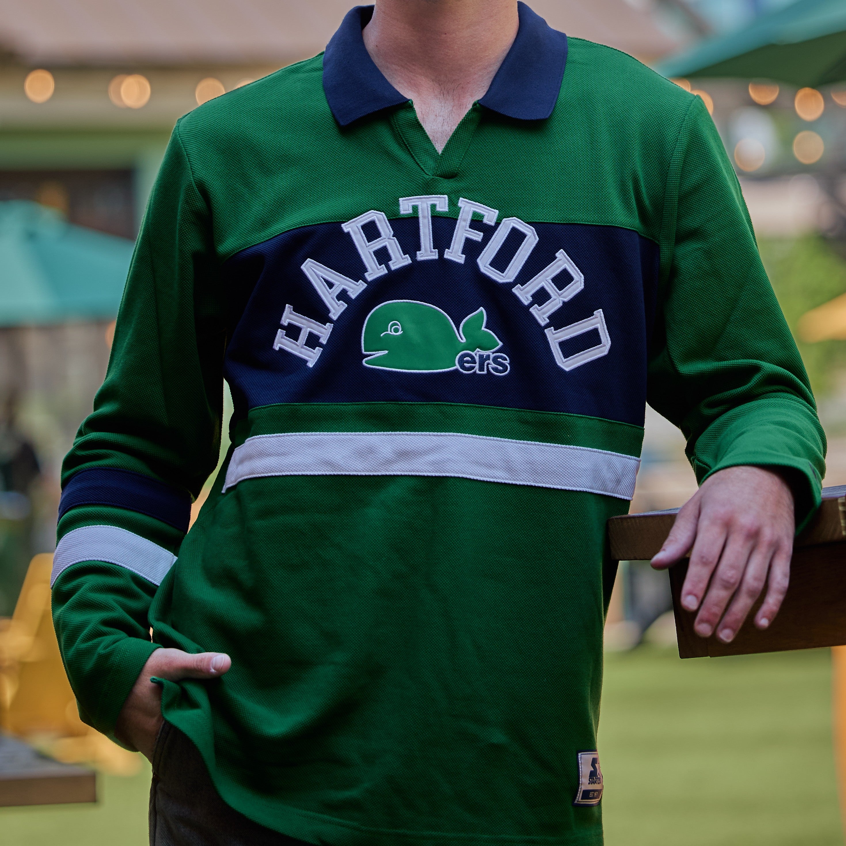 Green, collared longsleeve with blue/white striping, "HARTFORD" arched in white with Pucky Whalers logo across chest