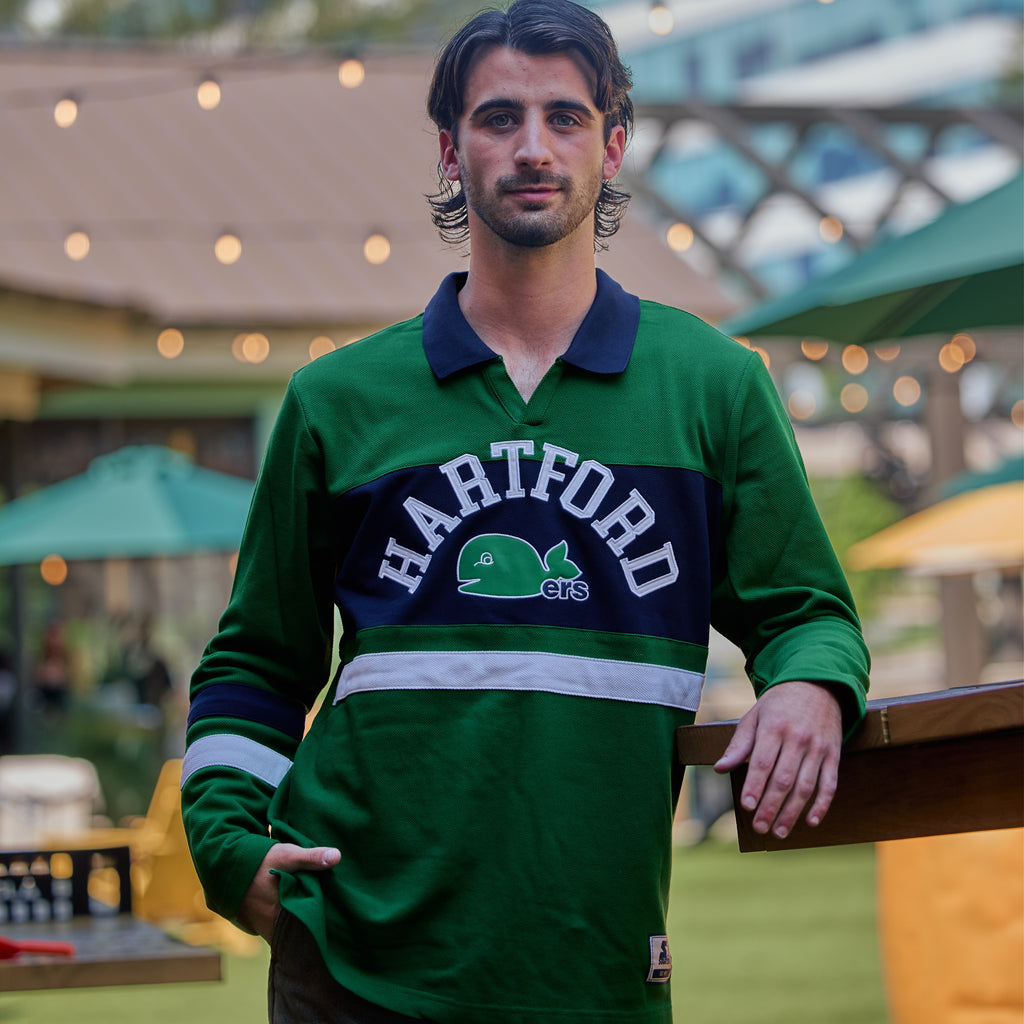 The top being worn by a model in an outdoor space