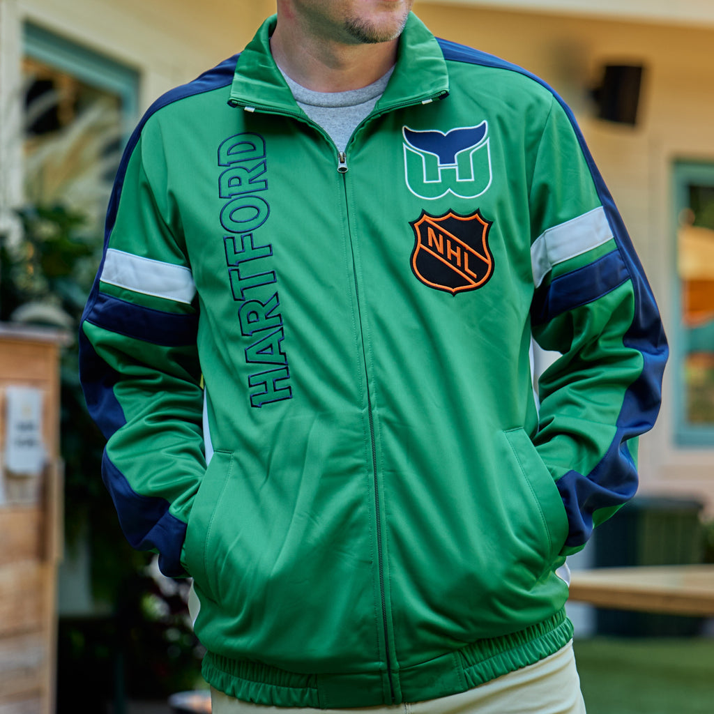 Front: Green zip-up jacket, navy/white trim, "HARTFORD" horizontally on right, Whalers tail/old NHL logo on left