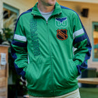 Front: Green zip-up jacket, navy/white trim, "HARTFORD" horizontally on right, Whalers tail/old NHL logo on left