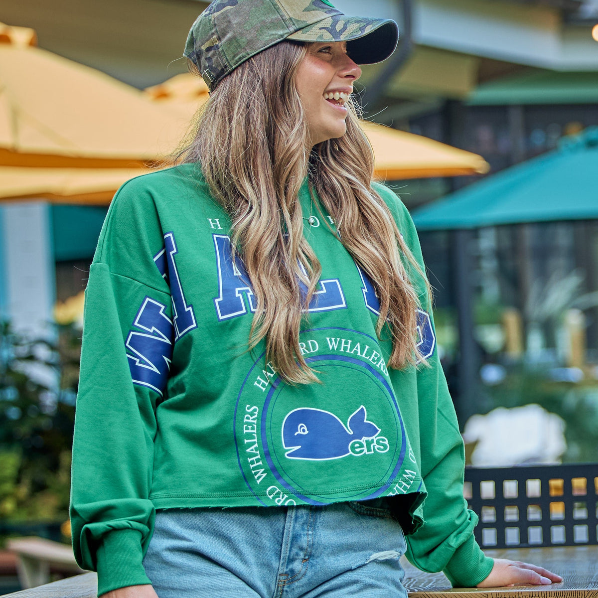 The cropped pullover being worn by a model outdoors