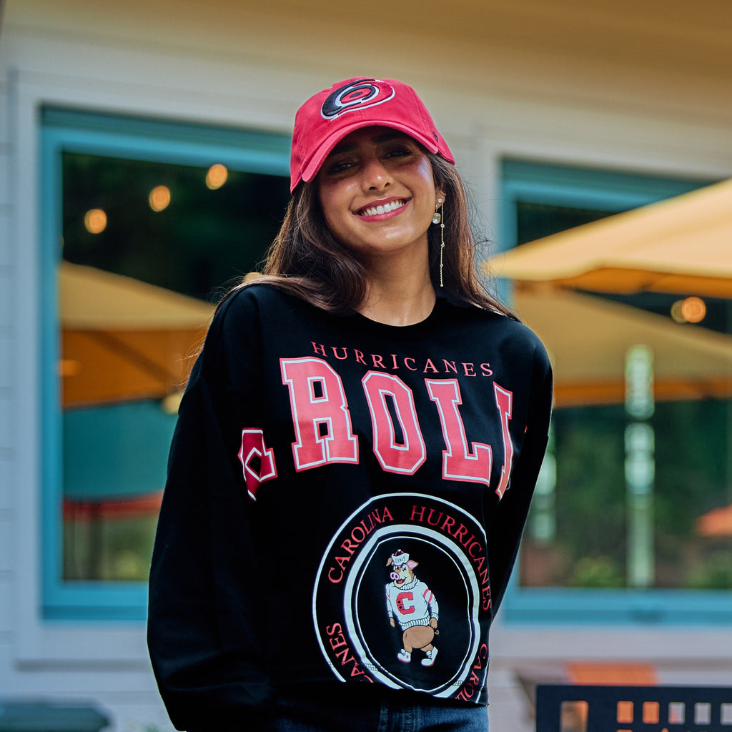 The top being worn by a model in an outdoor space