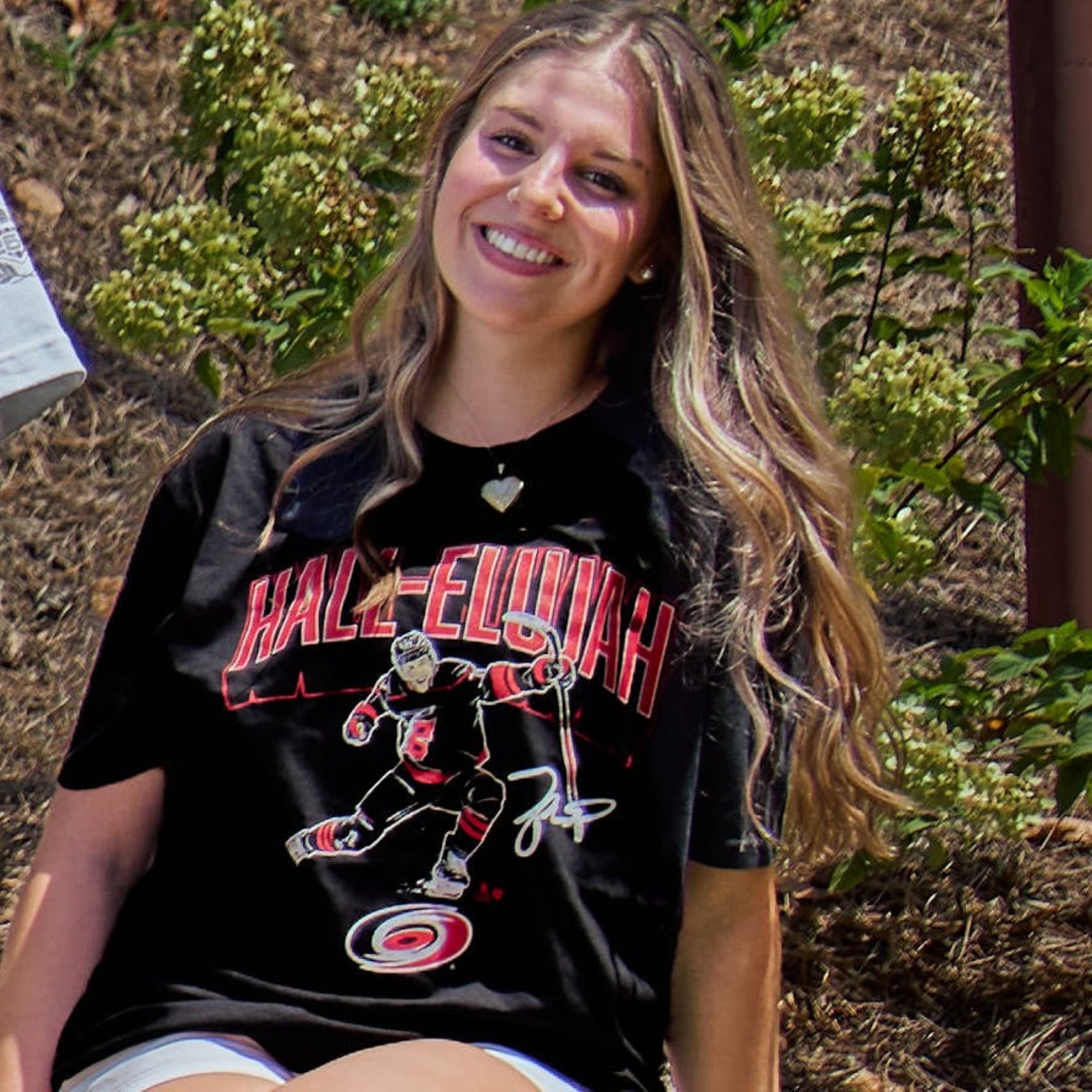 The tee being worn by a model in an outdoor area