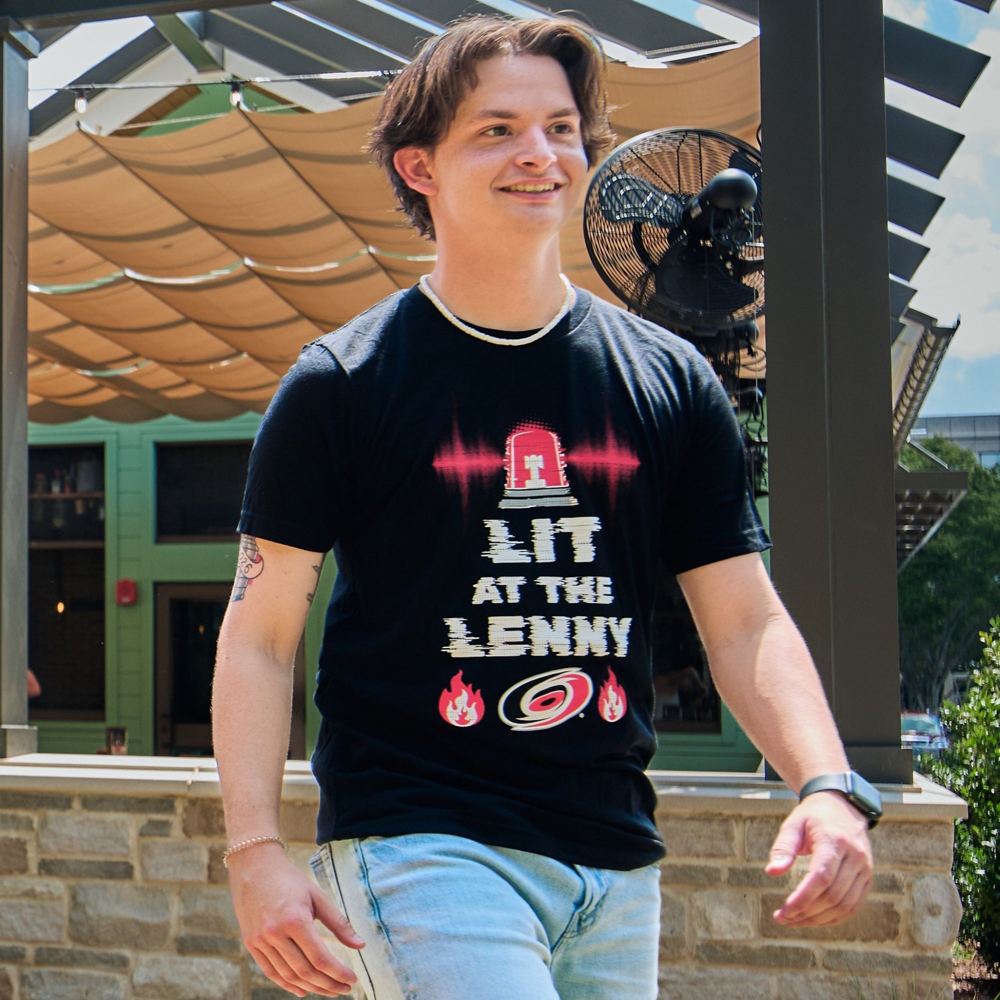 The tee being worn by a model in an outdoor area