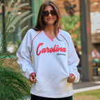 The pullover worn by a model who is outdoors and wearing sunglasses