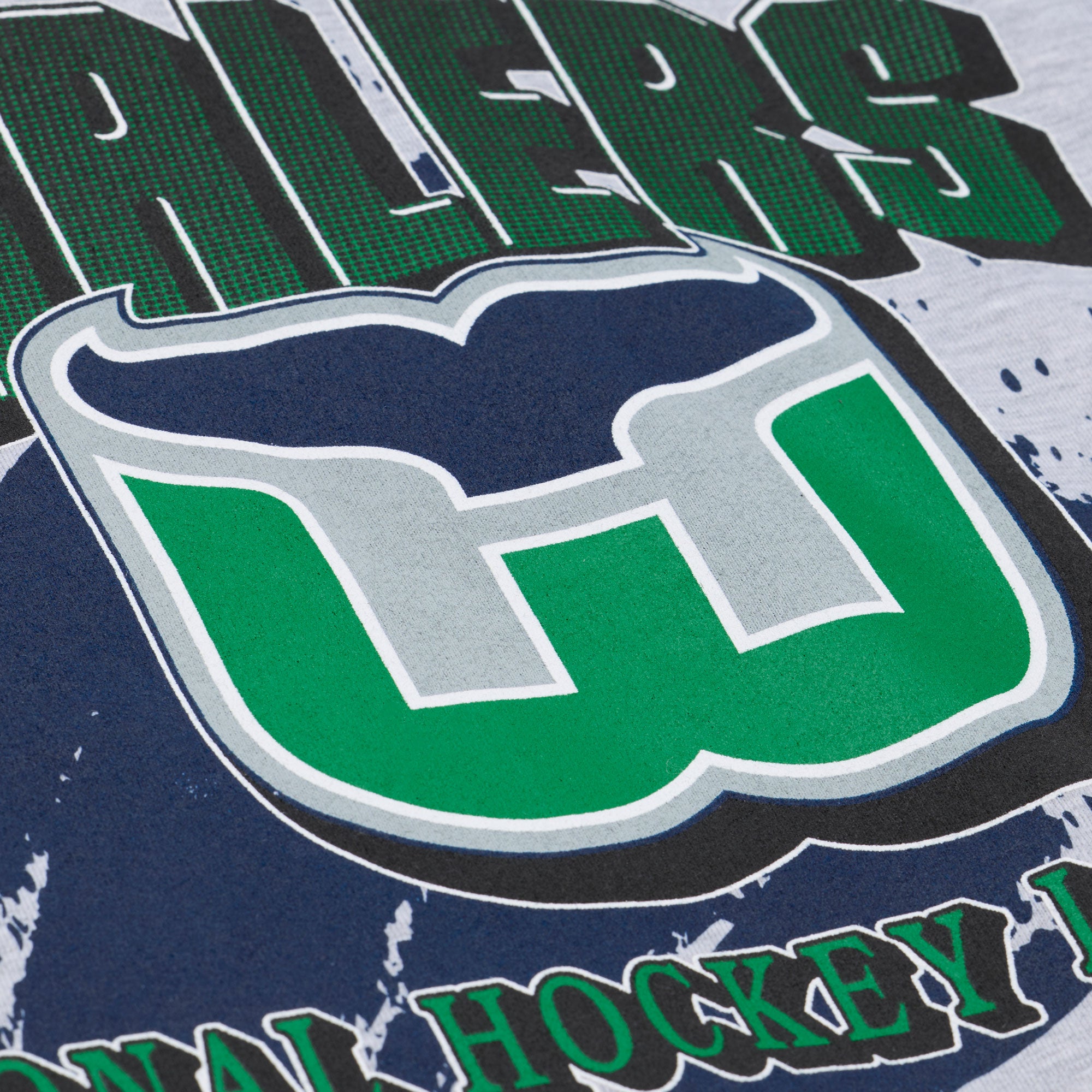 Close up of the art on front, featuring the Whalers Tail logo