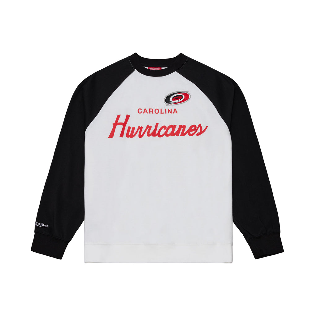 White crewneck, black shoulders/sleeves; "CAROLINA HURRICANES" in red across chest with Primary logo above