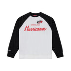 White crewneck, black shoulders/sleeves; "CAROLINA HURRICANES" in red across chest with Primary logo above