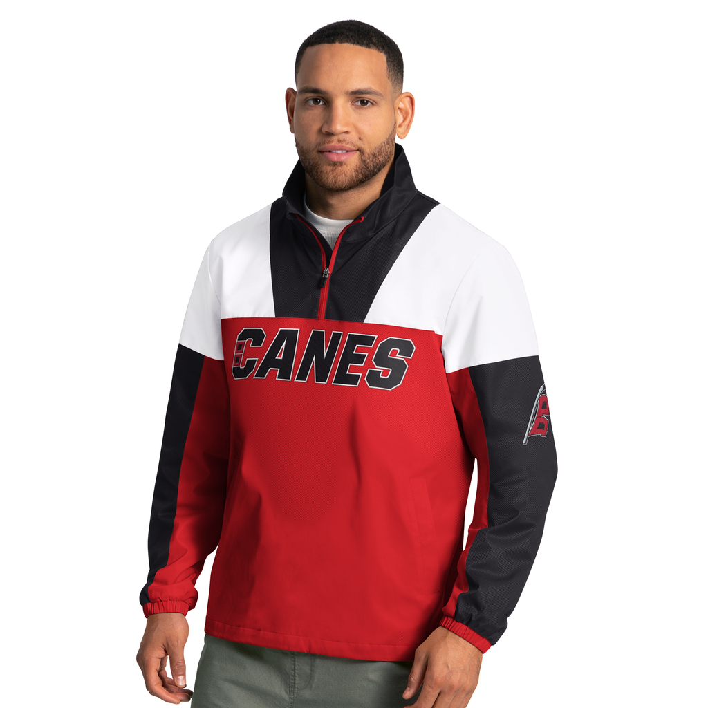 Front: Red half-zip, white shoulders, black trim; "CANES" wordmark across chest, Flags logo left sleeve