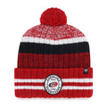 Front: Red cuffed beanie with black/white accents, ovular patch on cuff, red pom