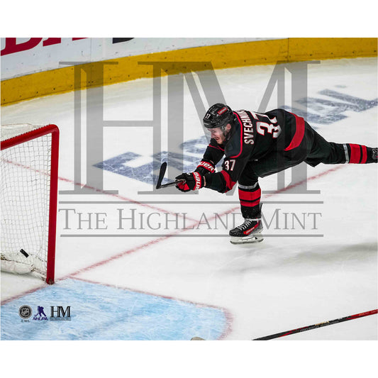 Photo of Andrei Svechnikov shooting during a home game