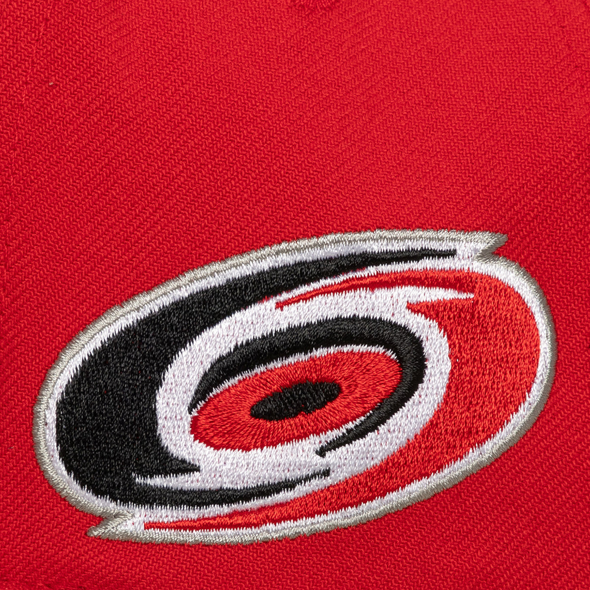 Left: Close up of Primary logo on left side of hat