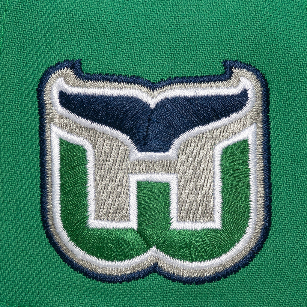 Left: Close up of the Whalers Tail logo on left side of hat