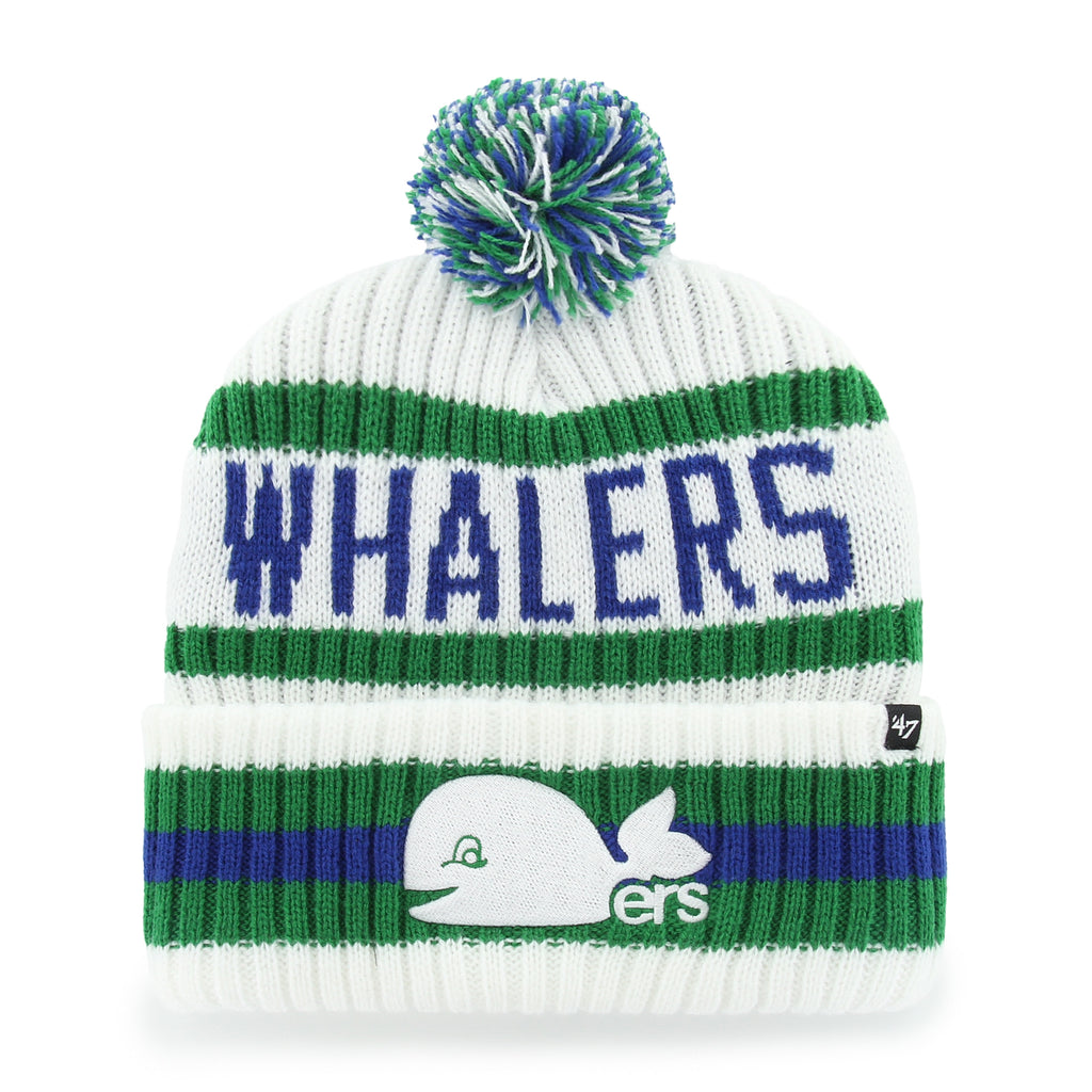 Front: White cuffed knit with pom, blue/green accents, white Pucky logo on cuff, "WHALERS" across front