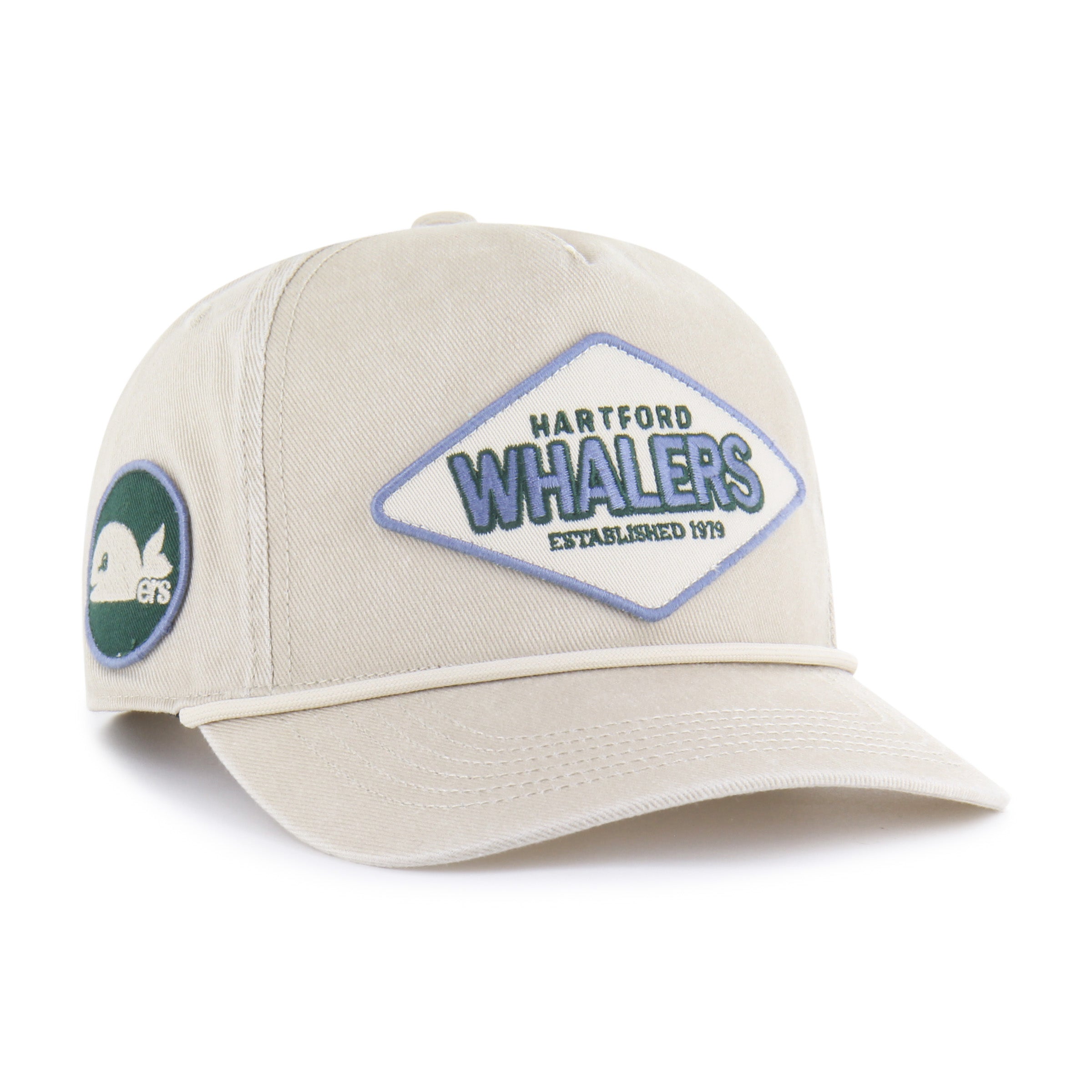 Front 2: Circular green and blue patch with Pucky whalers logo on right