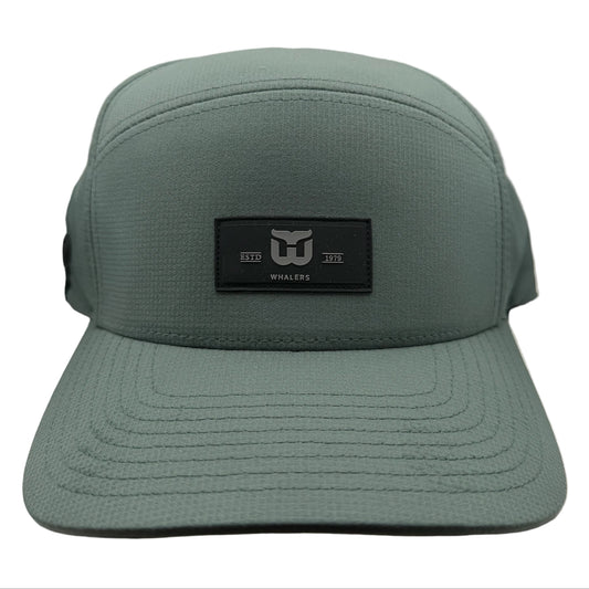 Green hat, black retangular patch on front with Whalers logo, "ESTD 1979"