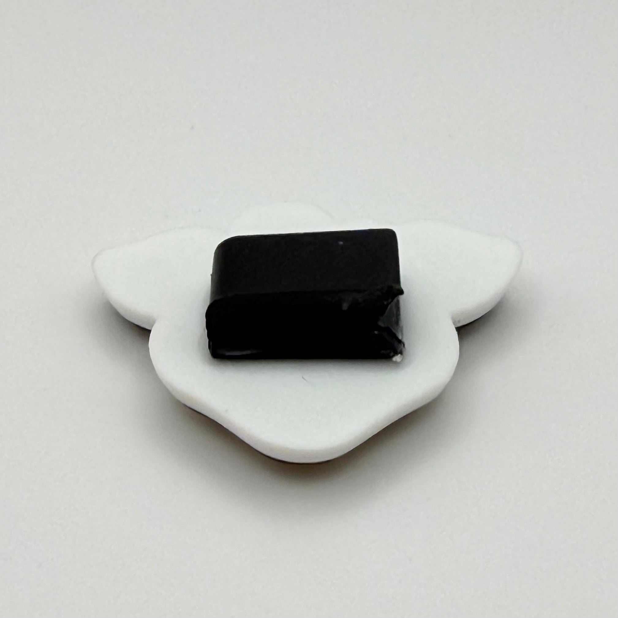 Close up of the backing of the Stormy clog charm