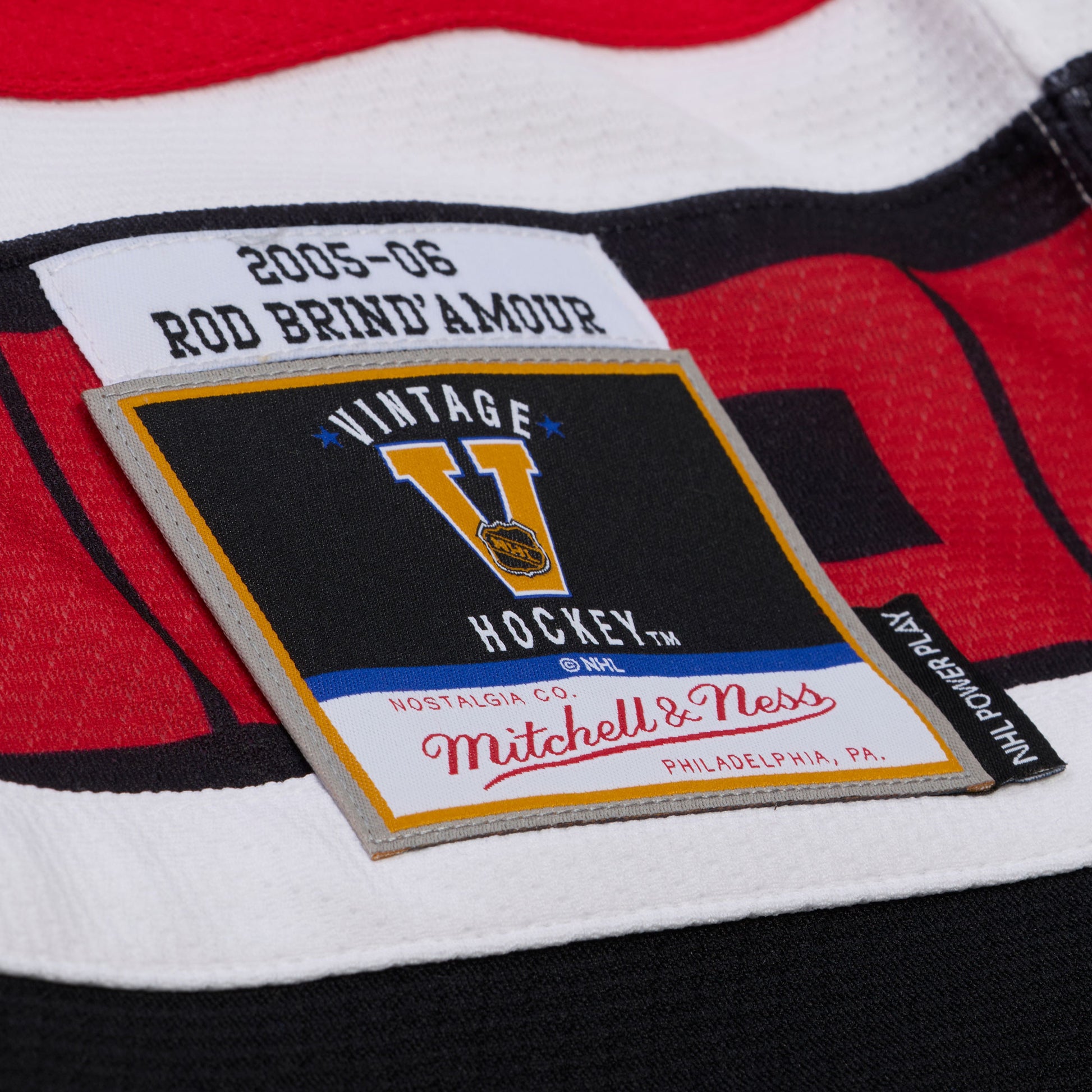Close up of the Vintage Hockey Mitchell & Ness patch on front left waist